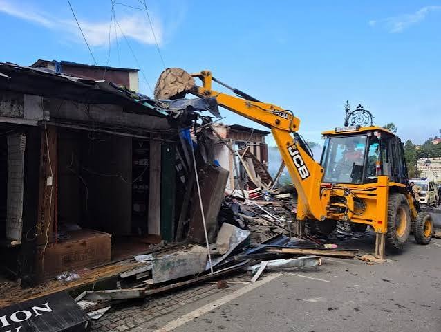 Major crackdown on unauthorized construction in Mussoorie; four shops demolished using a JCB.